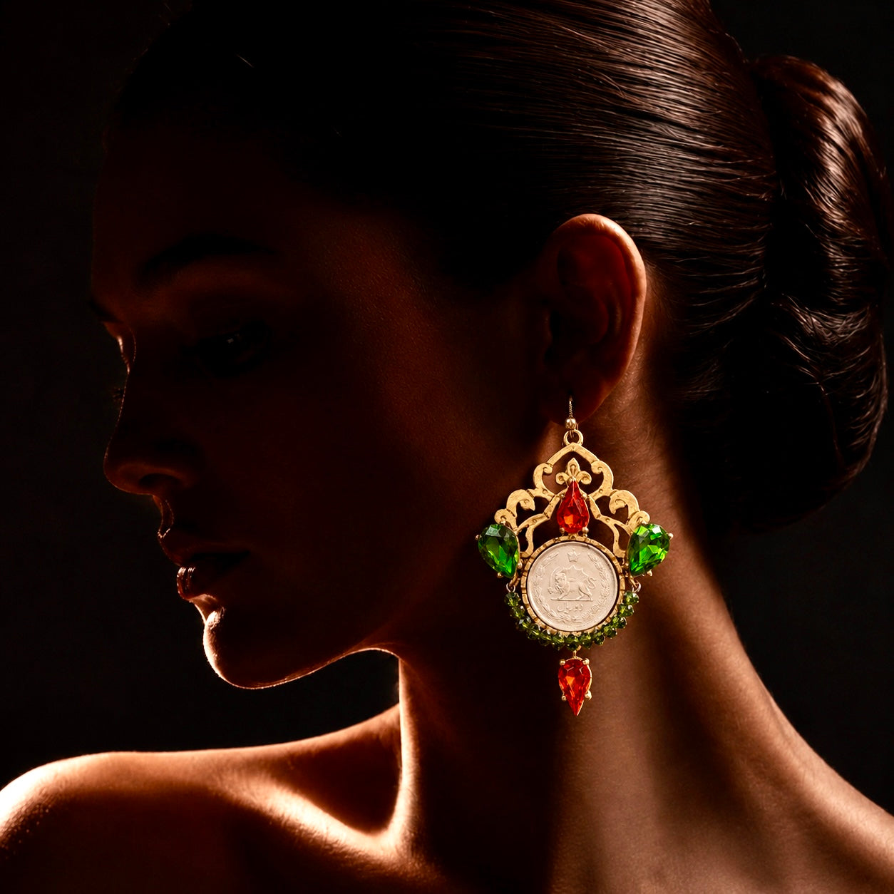 One-of-a-kind handmade statement earrings featuring authentic Pahlavi-era coins, sparkling red and green crystals, and intricate vintage-inspired detailing. A unique collector’s piece by Baharnaz Gallery. Only one pair available.
