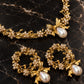 Handmade gold-plated brass pearl bow necklace and earrings jewelry set on black marble