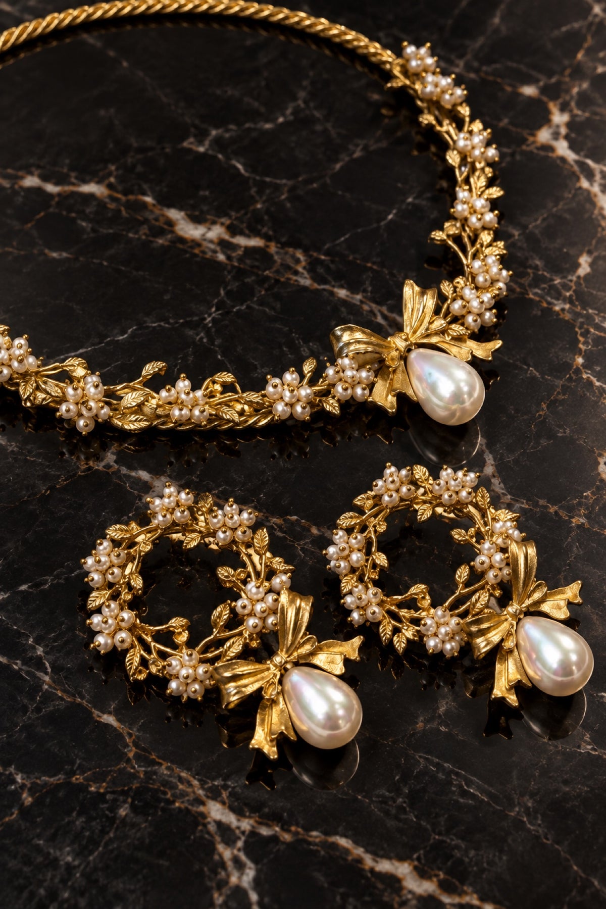 Handmade gold-plated brass pearl bow necklace and earrings jewelry set on black marble