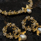 Gold-plated brass pearl bow necklace collar and wreath earrings on black marble