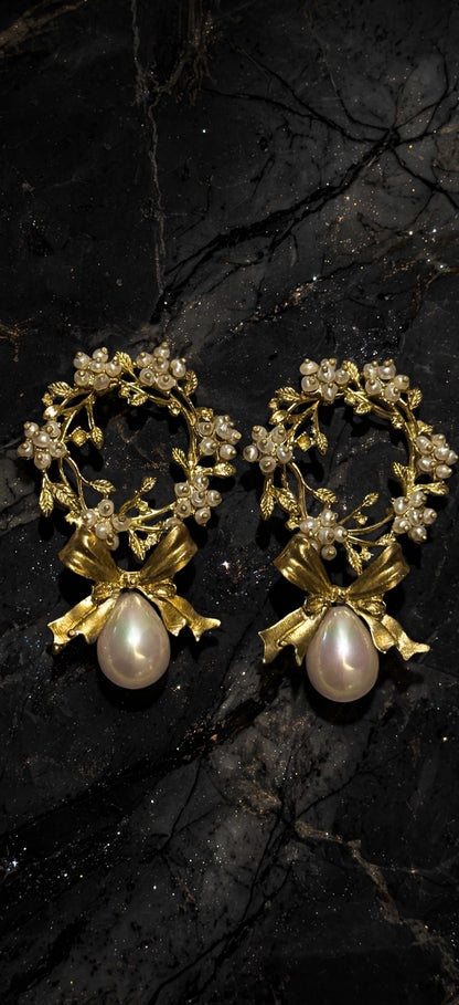 Handmade gold-plated brass pearl bow wreath statement earrings on black marble